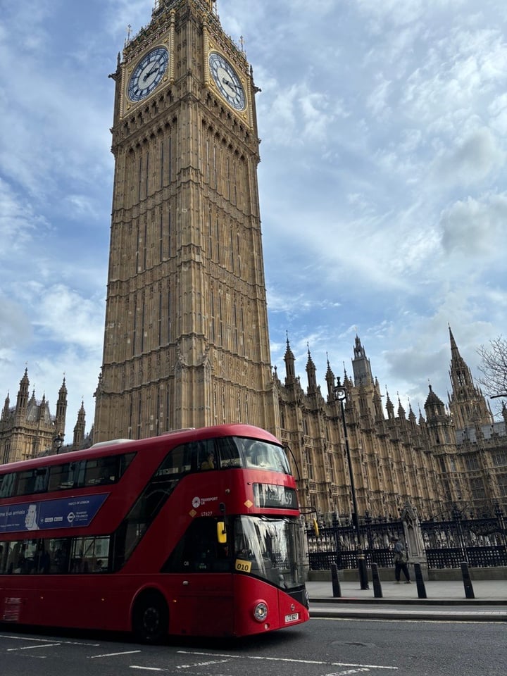 Photo of a London Bus driving past Big Ben