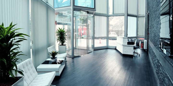 Image of We Are Digitals reception on the ground floor. Shows a small table and chairs with glass doors and a reception desk on the right.