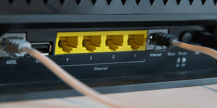 Back of a computer device is shown with ethernet sockets labelled. 