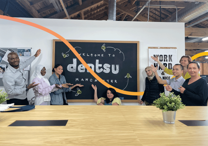 Our Greater Manchester Digital Marketing learners posing infront of Dentsu signage