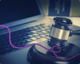 A computer and gavel with a purple connecting line