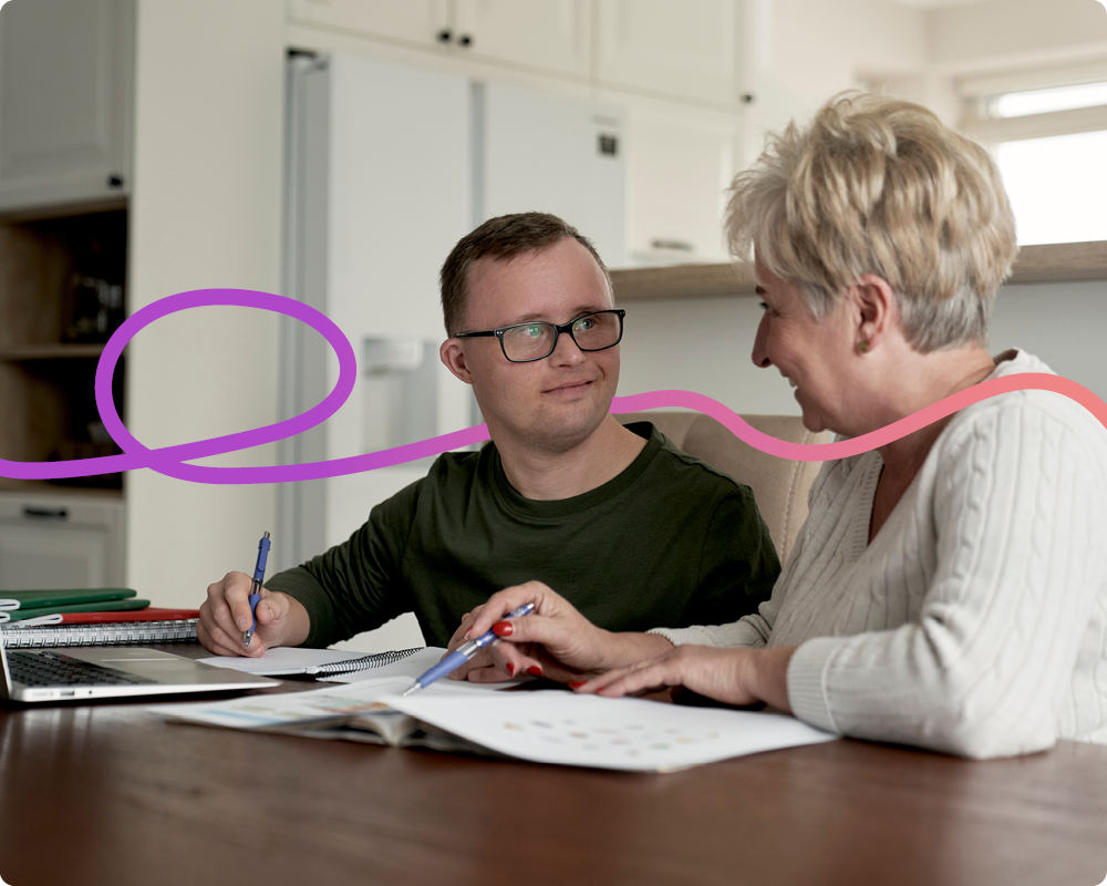 An image of a young man and older woman completing some paperwork