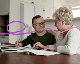 An image of a young man and older woman completing some paperwork