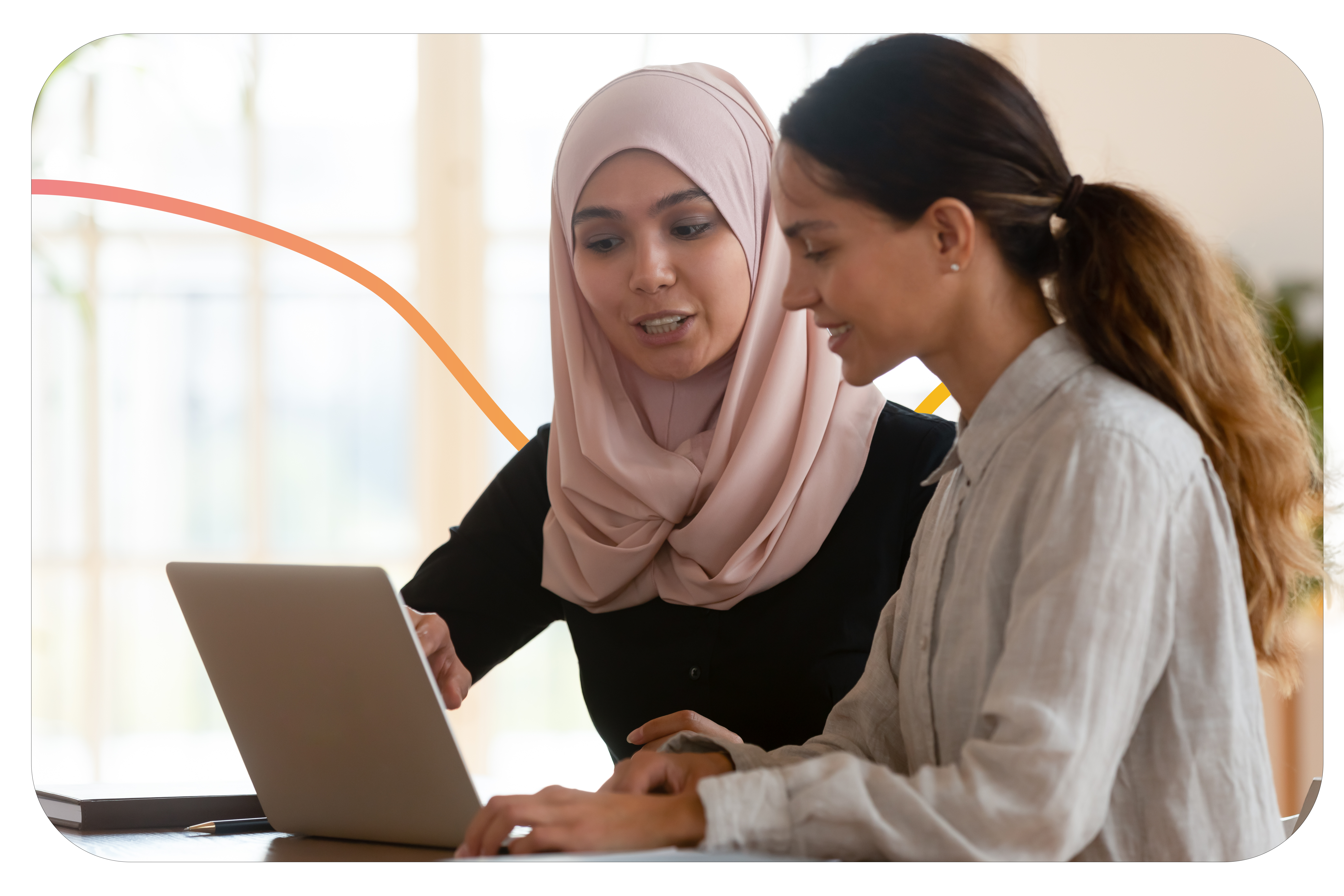 Trainer explaining how to use online budgeting tool to a woman