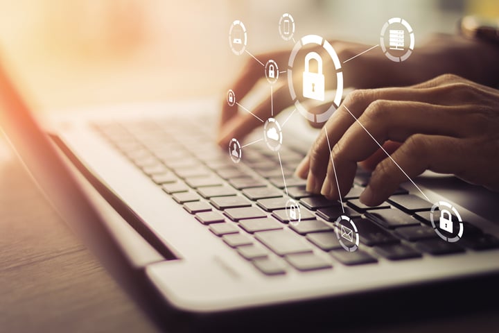 Person putting in password on laptop