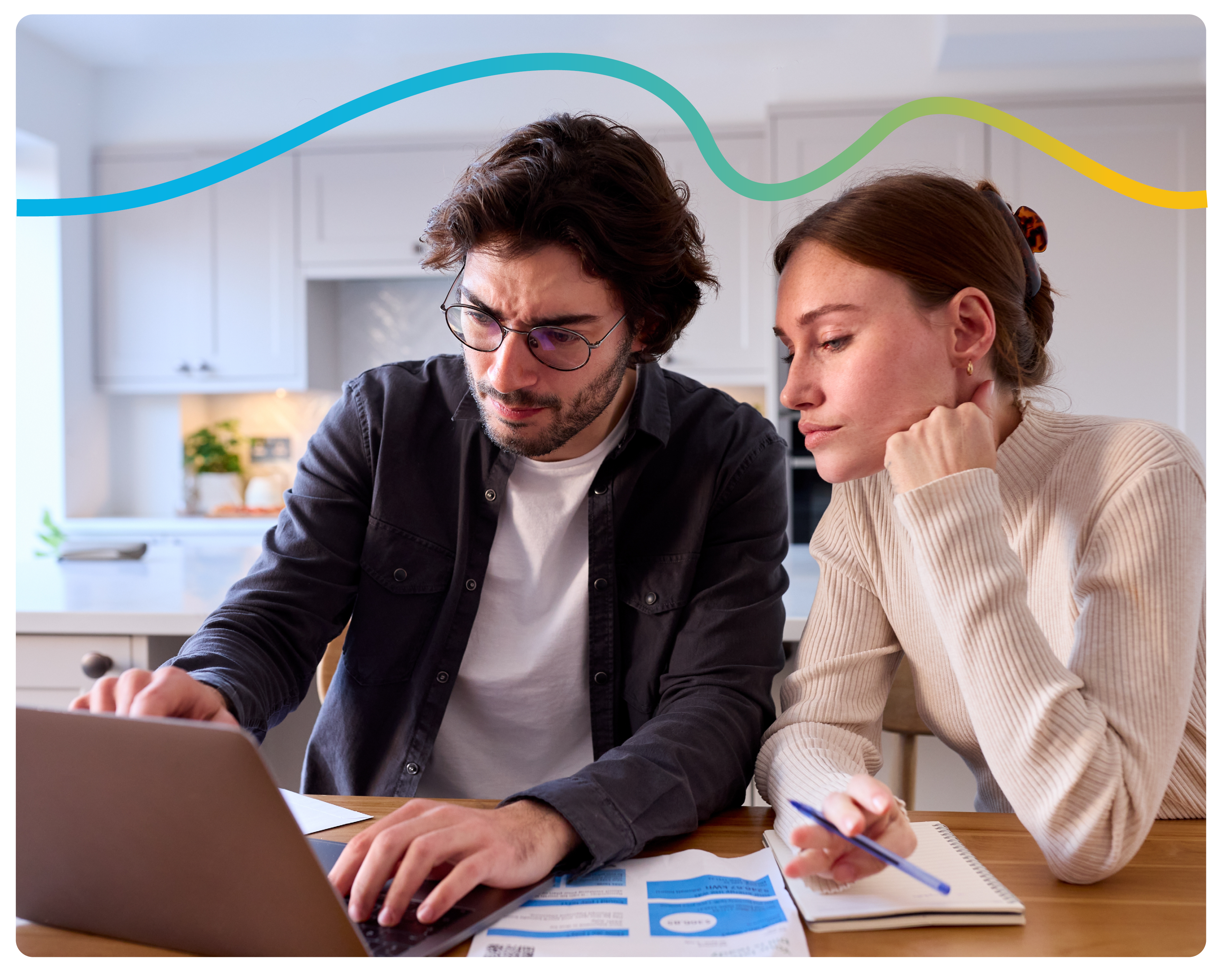 A young couple looking into their energy bill breakdown on their laptop