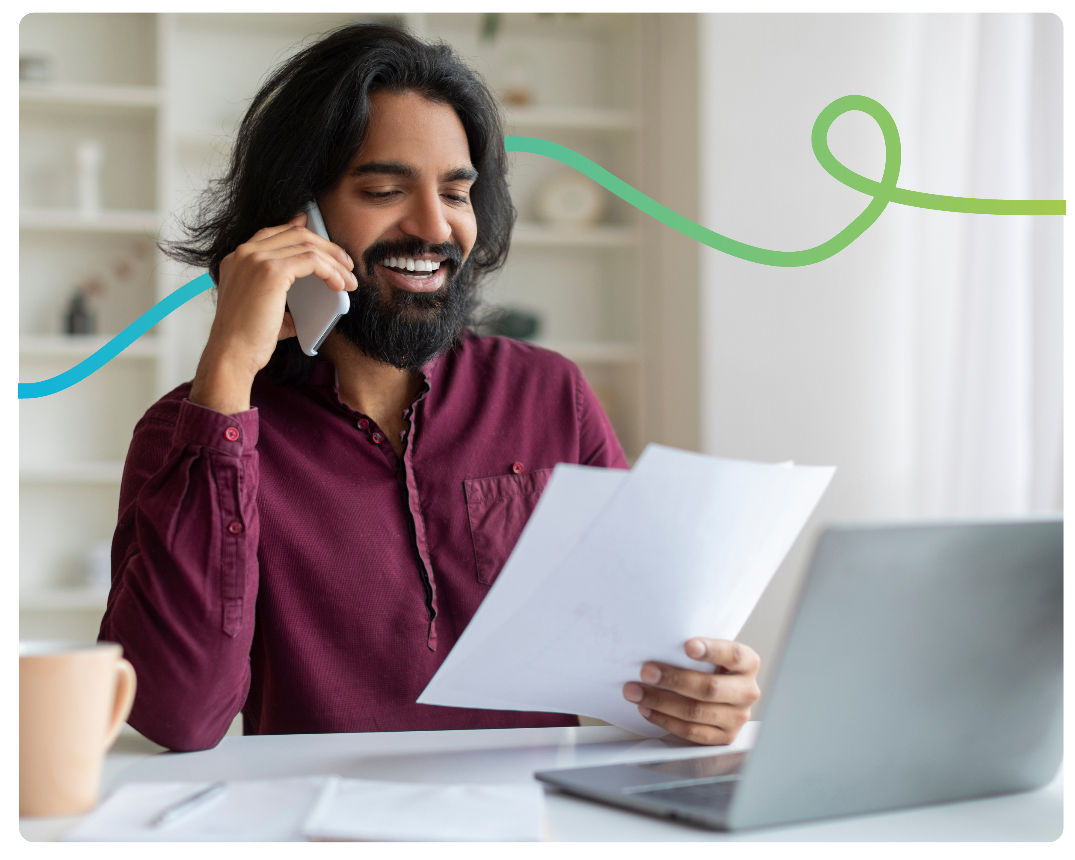 A man on the phone, holding his energy bill smiling