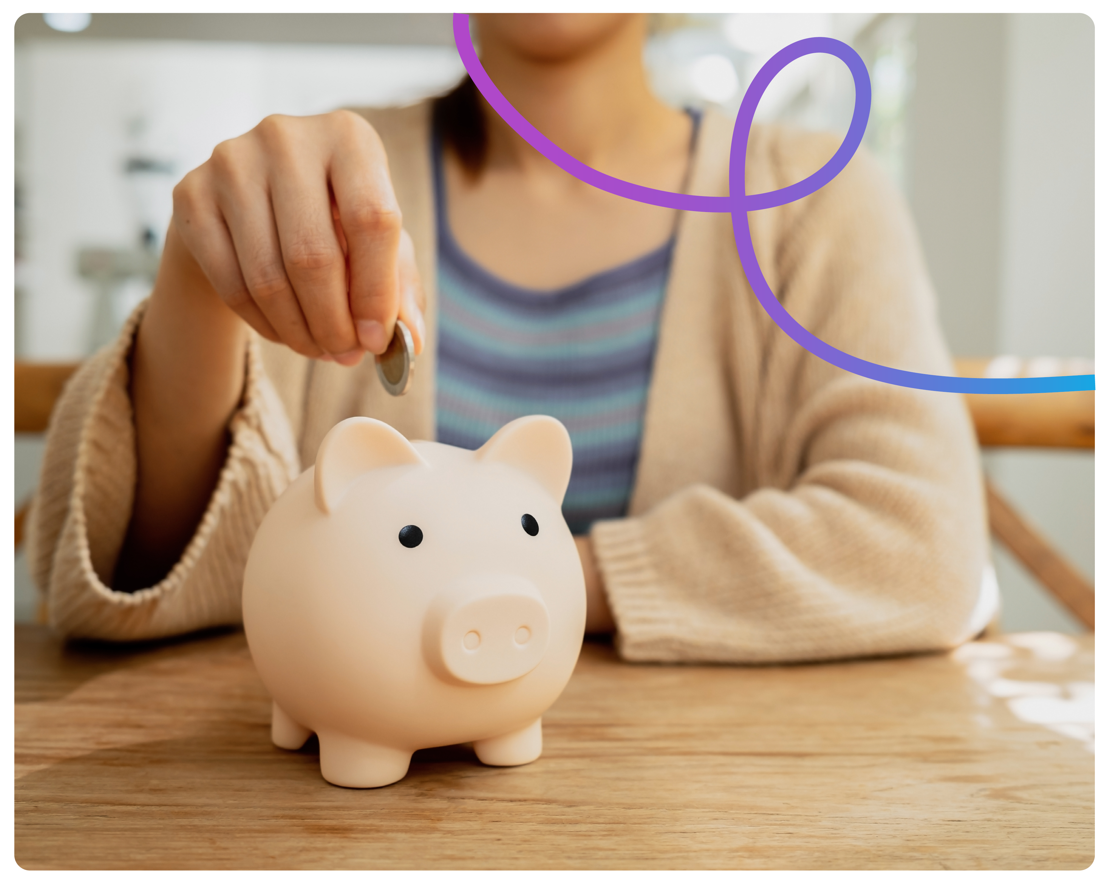 A close up of a womans hand putting a pound coin in a piggy bank