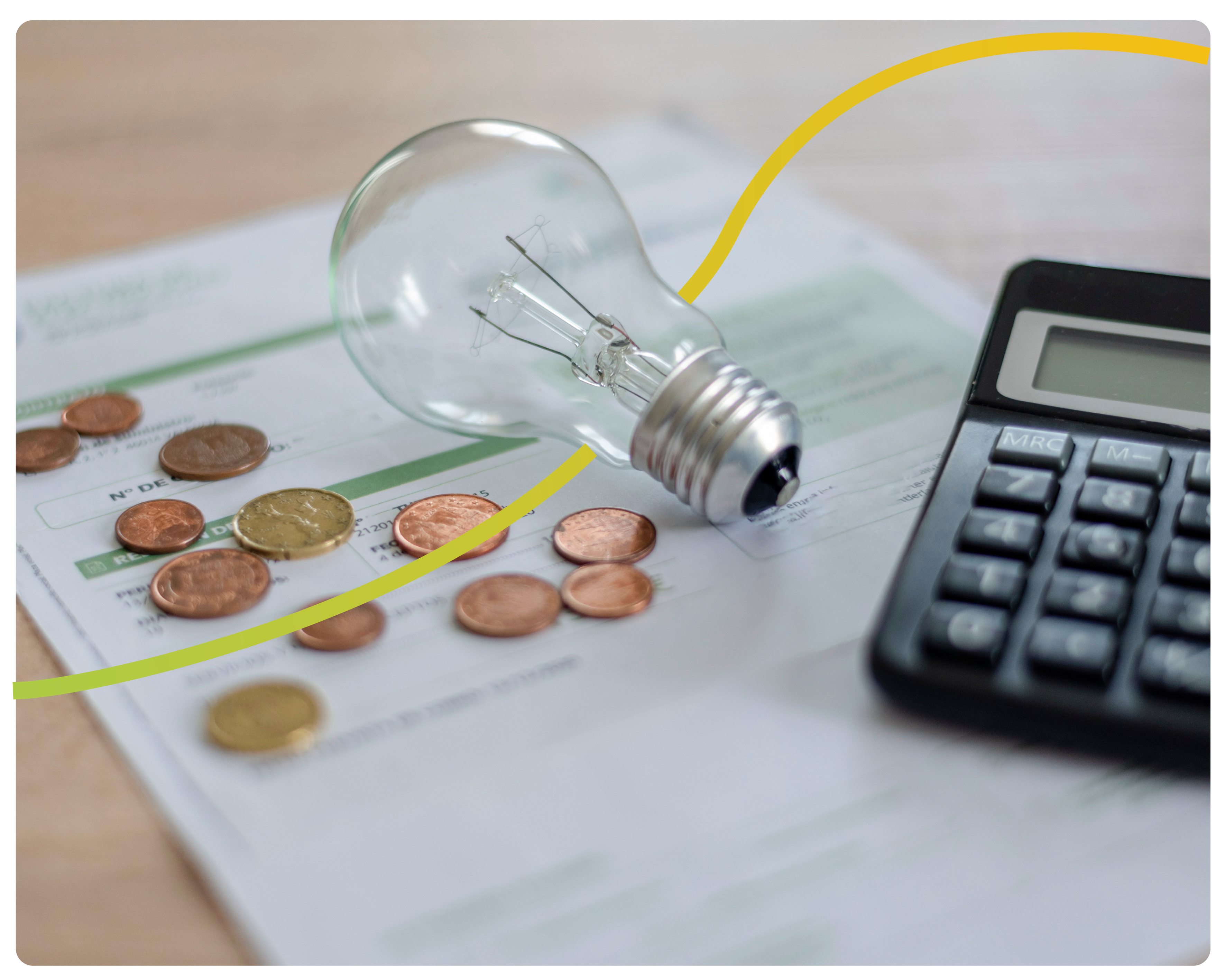 An energy bill with a calculator, copper coins and a lightbulb placed on a table