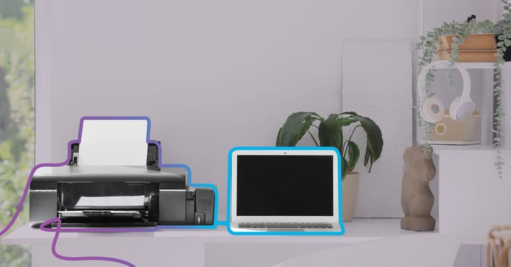 A printer and laptop on a desk, circled by a wavy line to highlight them as vampire devices.