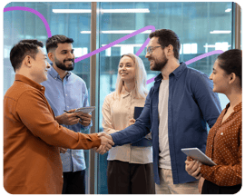 Image of a man shaking another mans hand, with other colleagues around
