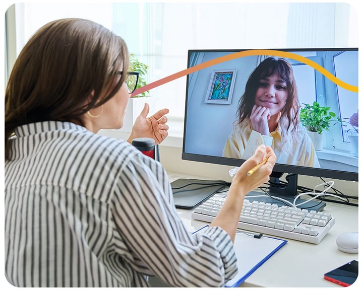 A debt advisor is talking to a Mental Health Breathing Space client over video call on her laptop.