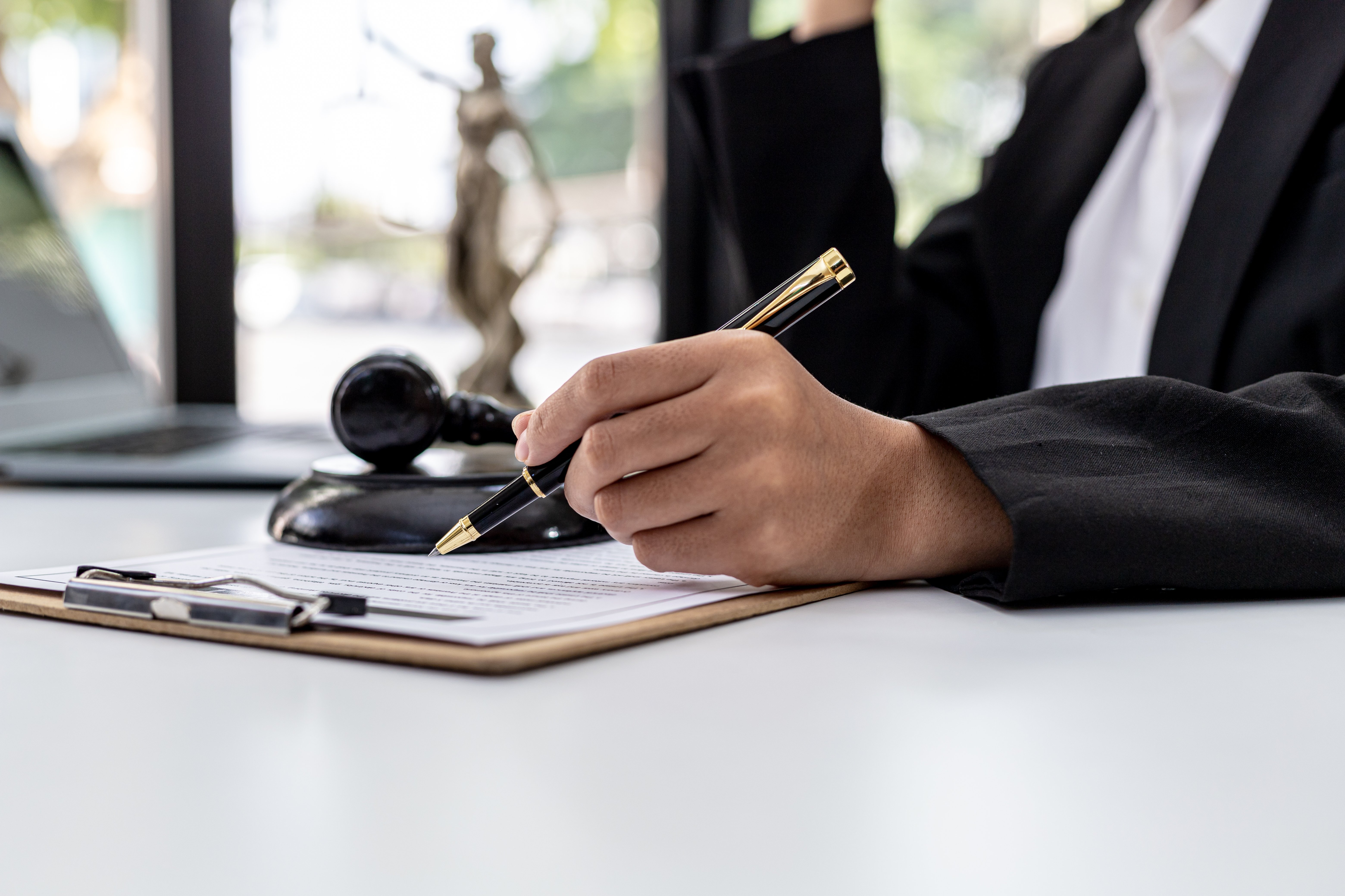 man with a pen writing a plea