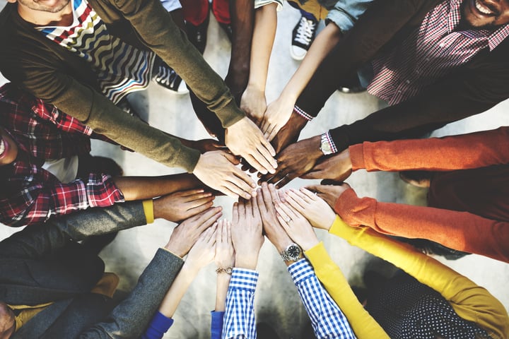 Group of diverse hands joining together