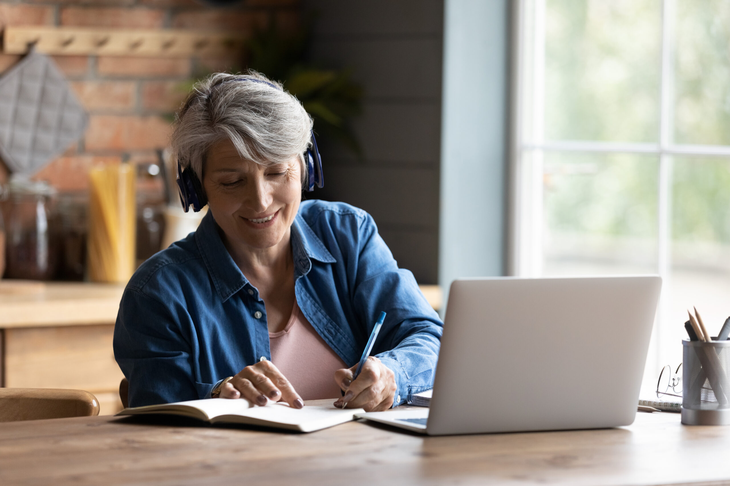 Woman using a laptop with headphones